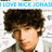 Pixelated image of a person with dark curly hair wearing a light-colored shirt, set against a white background with faint floral patterns.