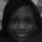 Black-and-white pixelated portrait of a person with shoulder-length hair, neutral expression, and visible facial features including eyes, nose, and mouth.