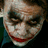 A four- shows a character with white face paint, dark eye makeup, and a red smile, wearing a dark blue shirt against a dark background