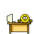 Yellow circular character with downturned mouth sits at desk with computer, repeatedly swinging brown hammer to smash monitor into fragments.