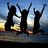 Silhouetted figures with raised arms against a sunset sky, rendered in pixelated style.