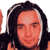 Pixelated static image of a person with long dark hair and light skin tone, cropped to show upper face and shoulders against white background.