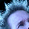A person with light-colored tousled hair appears in two side-by-side frames; the right frame shows blue text on their forehead.