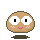 Pixelated character with large white eyes, black pupils, pink cheeks, and a smiling mouth on gray background.