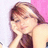 A pixelated close-up of a person with light brown hair, wearing a dark top, resting their head on their hand against a pink and white background.