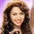 Pixelated image of a person with long brown hair wearing a light-colored top against a gradient background transitioning from purple to beige.