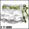 Static image of white ruffled fabric with a green striped ribbon tied in a bow on the right side, set against a white background with faint pink dots.