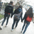 Three figures walk away on a snowy path; the rightmost figure's red backpack shifts position across frames.