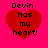 Four identical red heart shapes on a bright pink background, each containing black pixelated text reading "Devin has my heart!" in four
