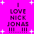 Bright pink background with white plus signs; four identical text blocks reading 'I LOVE NICK JONAS !!!!...!!!!' in black pixelated font, arranged in a
