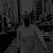 Black-and-white animated sequence showing a person in a cityscape background with changing poses and facial expressions.
