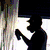Silhouette of a person holding an object against a bright background with vertical lines, transitioning to green foliage and yellow flowers.