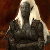 Pixelated figure with long light hair wearing dark clothing against a brown background.
