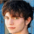 Pixelated image of a person with dark hair and green eyes, alongside yellow text reading "Team Jasper GUS scari make a man SEXY!!" on white background.