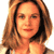 Static pixelated image of a person with long brown hair and light skin tone, cropped to show upper shoulders and face against white background.