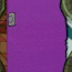 Green cartoon character with large white eyes peeks from behind purple door in tiled hallway, tongue out, black limbs visible.