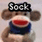 A static image of a sock monkey with red mouth, blue cap, and blue scarf, overlaid with text labels in a