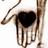 A pixelated image of a hand with a heart-shaped cutout, accompanied by red text on light pink and gray backgrounds.