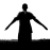 Black silhouette of a humanoid figure with outstretched arms against white background, standing on dark horizontal base.