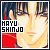 Pixelated image of a person with light skin and dark hair, wearing red clothing, with text reading "MAYU SHINJO" in bold black letters on a white background.