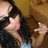 A pixelated image of a person with dark hair and a black top, making a hand gesture, with red text overlaid on the right side.
