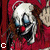 A static image of a clown with white face paint, red lips, and brown hair against a red background with text fragments.