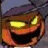 Pixelated cartoon face with glowing yellow eyes, orange-red cheeks, and a dark mouth against a muted background.