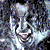 Pixelated static image with abstract light and dark shapes in blue, gray, white, and black tones against a dark background.