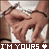 Pixelated static image of two figures in close embrace with visible hands and partial faces, overlaid by bold text at the bottom.