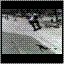 A skater performs a trick on a ramp, transitioning from grayscale to color with background trees and a red vehicle visible.
