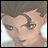 Pixelated anime-style character face with brown hair and brown eyes, next to black background with white text reading 'Anime IM' and 'com'