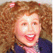 A sequence of animated frames showing a person with curly red hair in pigtails, transitioning from a side profile to a front-facing view with a wide smile, accompanied by purple 'LOPAVILLE' text and 'GOOGLE IT!' variations.