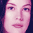 A pixelated image of a woman's face with golden rings and text from The Lord of the Rings films, including 'The Return of the King' title.