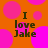 Orange background with pink polka dots and four identical text blocks reading "I love Jake" in dark brown pixelated font.
