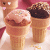 Animated sequence of ice cream cones with pink and chocolate toppings, showing subtle changes in cone positions and background elements.