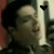 A person with dark hair in a black jacket appears across four , each showing different heart symbols above the head