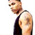 Pixelated image of a person in a black tank top with a visible shoulder tattoo, cropped to show upper body against white background.
