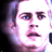 Pixelated close-up of a person's face with dark hair and blue eyes, rendered in pink/purple tones on a white background.