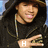 A person in a black hoodie and gold chain makes hand gestures with text overlays changing from H to HO to HOT to HOTT.