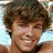 A four- shows a young man with brown hair smiling, performing skateboard tricks, and embracing another person outdoors