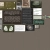 Static pixel grid with multiple rectangular sections in muted brown, gray, white, and green tones arranged on a neutral background.