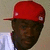 A person wearing a red cap with white circular patches and a light-colored shirt, shown in four positions with slight head angle variations
