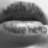 Grayscale pixelated image of a rounded object with dark top and light bottom sections, appearing as a stylized mouth or lip shape.