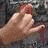 A hand makes a gesture with fingers extended and thumb tucked, while another figure winks with one eye closed.