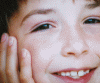 A child's face appears in multiple showing a hand touching the cheek, with partial background elements visible