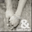 Black-and-white image of two hands clasped with an ampersand symbol, paired with pixelated text expressing love and promises.