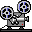 Two pixel-art film projectors with rotating reels, gray bodies, white accents, and red indicator lights on a light gray background.