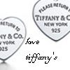Two heart-shaped silver-tone metal tags with 'TIFFANY & CO. NEW YORK 925' text, a 'love' word, and 'tiffany's' script below, on white background.