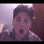 Animated contact sheet showing three frames of a person with changing facial expressions and text below each frame, all labeled "andy" above "milonakis" in pixelated font.