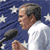 Pixelated image of a man speaking into a microphone with American flag elements and "W'04" text on blue background.